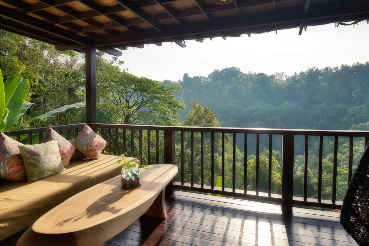 Private balcony of the Sunrise View Villa with golden morning light and rainforest views in Ubud, Bali