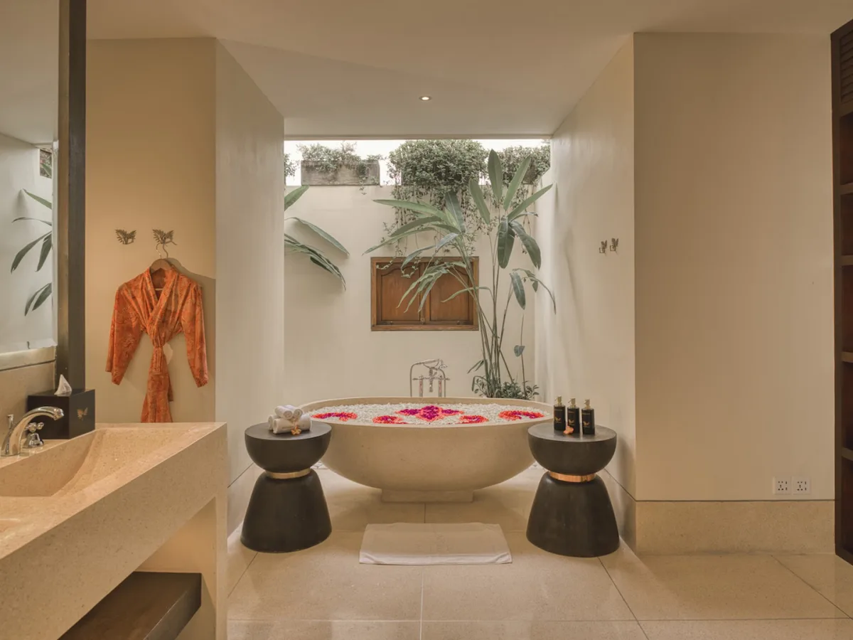 Jungle View Royal Suite bathroom with outdoor flower bath, vanity, and wooden wardrobe in Ubud, Bali