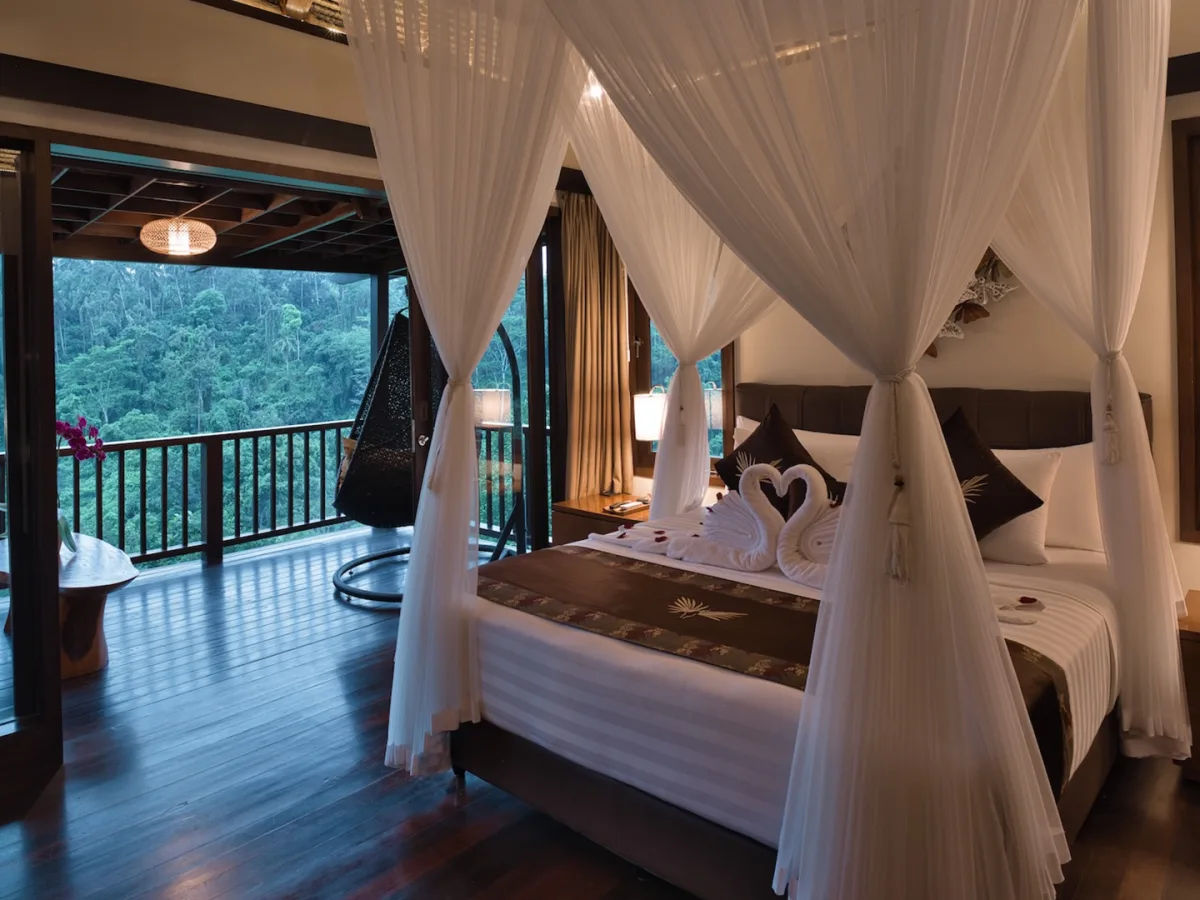 Jungle View Villa bedroom with canopy bed, private balcony, and rainforest views in Ubud, Bali
