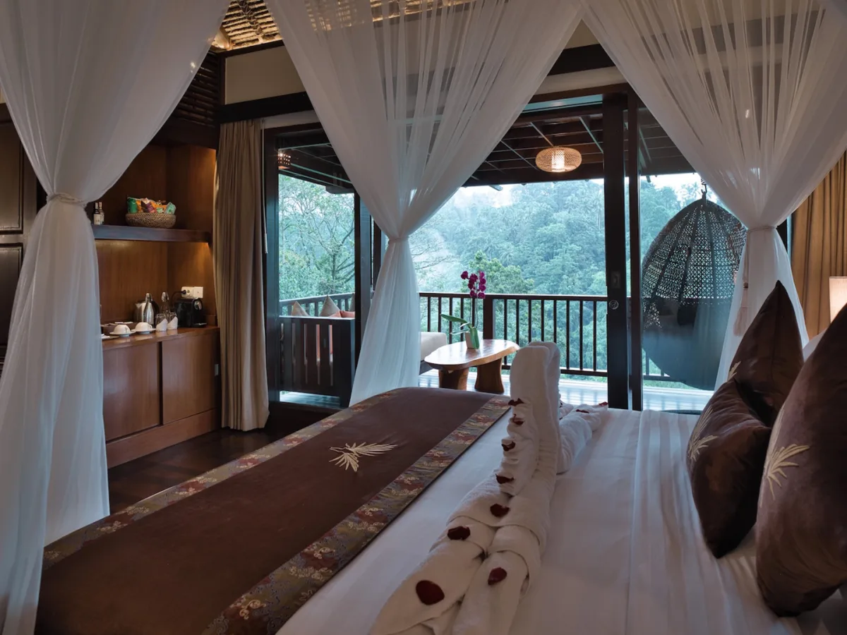 Panoramic Jungle View Villa bedroom with canopy bed, private balcony, and rainforest views in Ubud, Bali