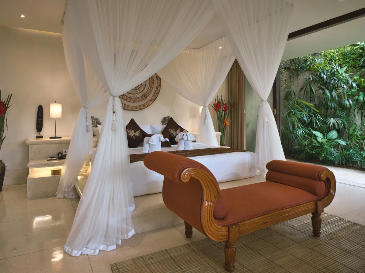 Canopy bedroom inside the Presidential Royal Suite with private garden views in Ubud, Bali