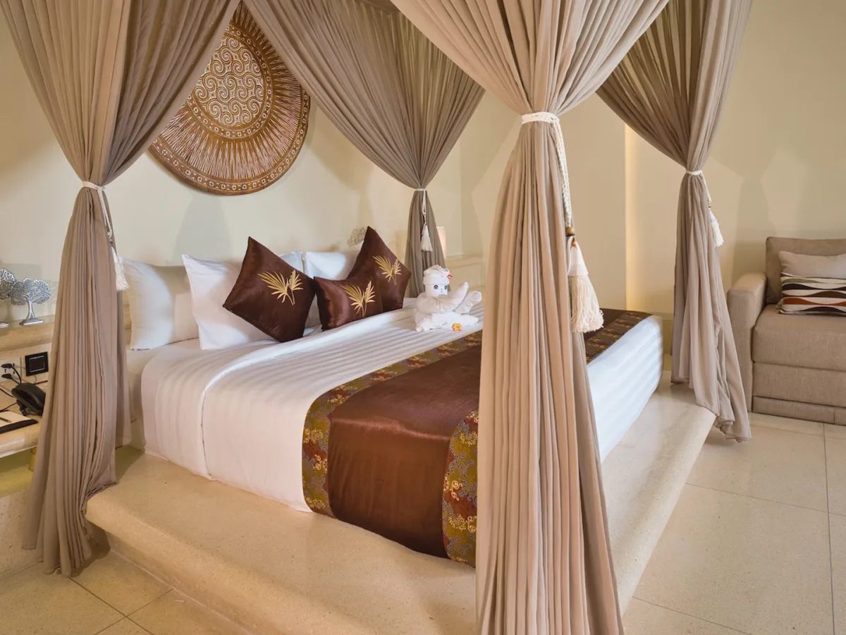 Private Garden Royal Suite canopy bedroom with elegant lounge area in Ubud, Bali