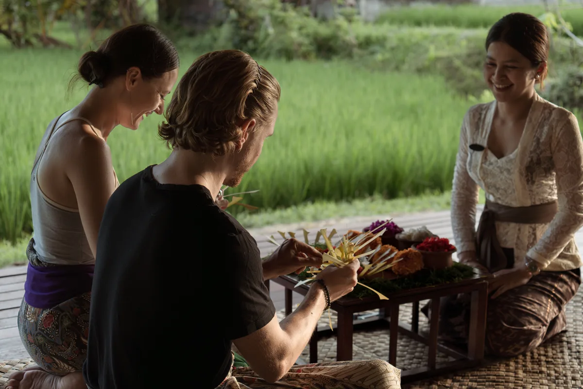 Guests enjoying a Balinese cultural experience at Nandini Jungle by Hanging Gardens in Bali.