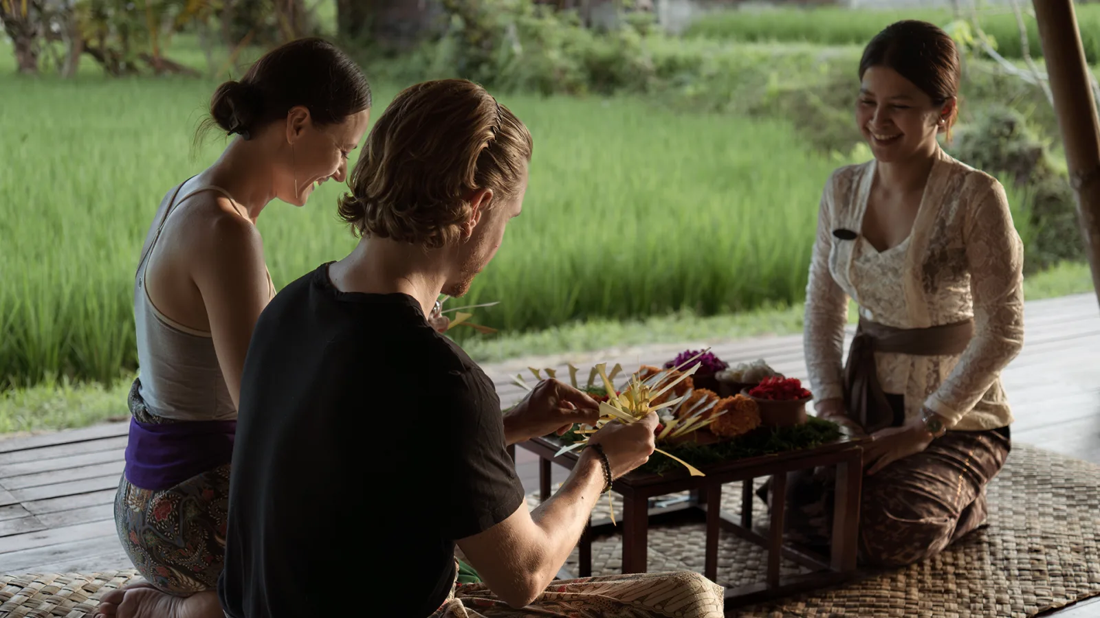 Guests enjoying a Balinese cultural experience at Nandini Jungle by Hanging Gardens in Bali.